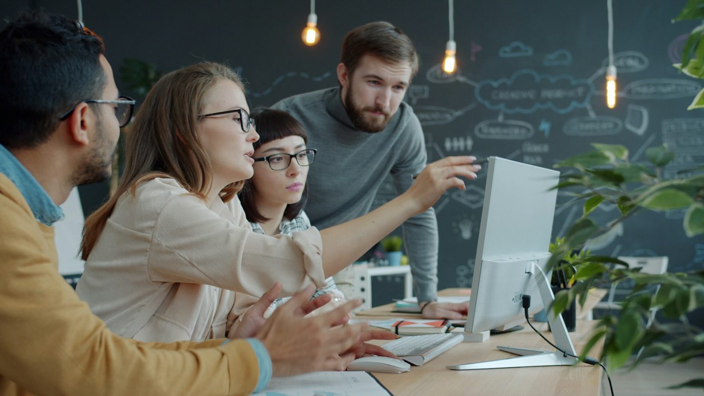 A designer coaching teammates through work on a shared screen